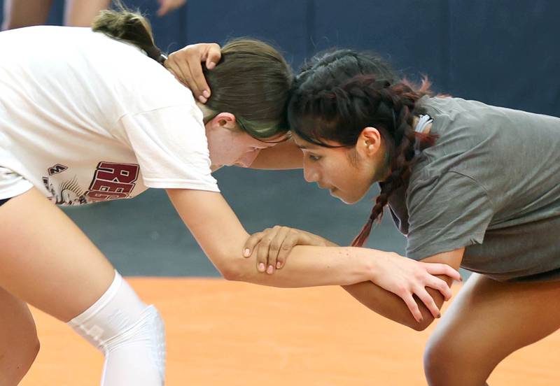 DeKalb female wrestlers Jade Weiss (left) and Alex Gregorio-Perez lock up Monday, June 27, 2022, during practice in the wrestling room at DeKalb High School. This will be the first year DeKalb will have a girls wresting team.