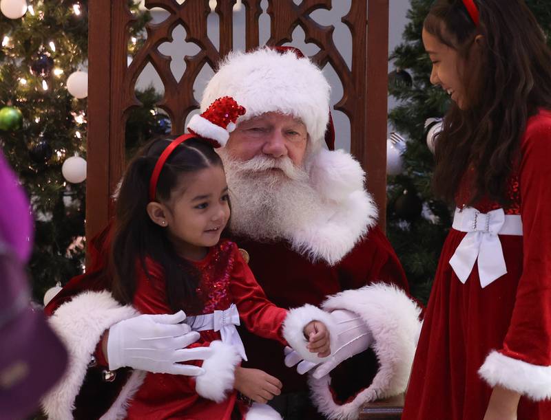 Joey Arias, 3, and Bianca Diaz, 11, visit with Santa at the Joliet Area Historical Museum at the Joliet Light Up the Lights Holiday Festival on Friday, Nov. 29, 2024.