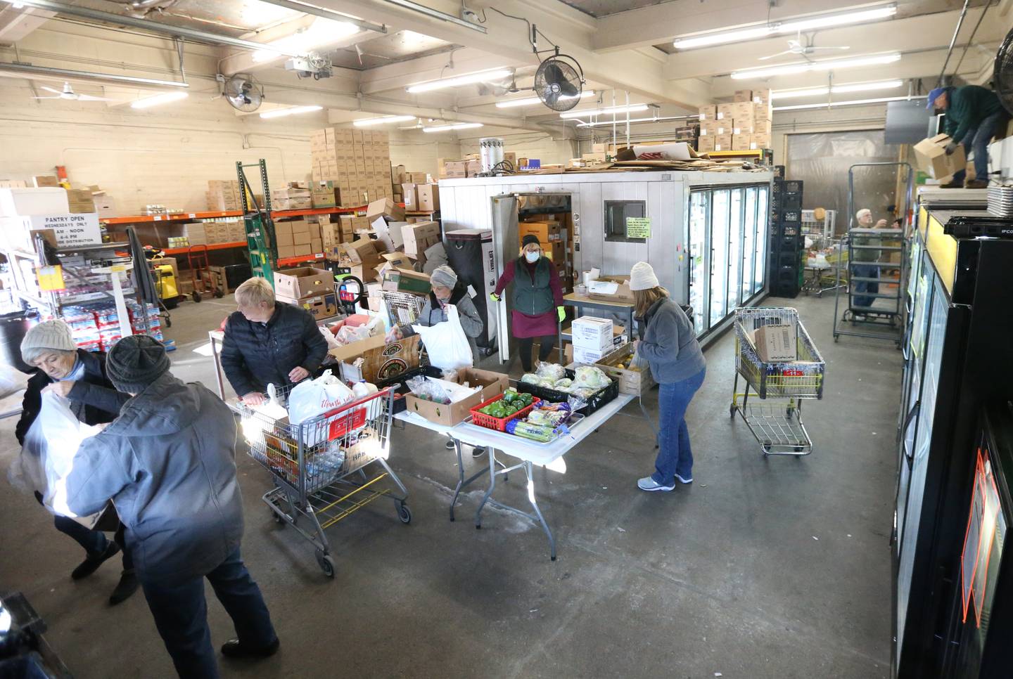Volunteers gather food for clients at the Hall Township Food Pantry on Wednesday, Nov. 30, 2022 in Spring Valley.