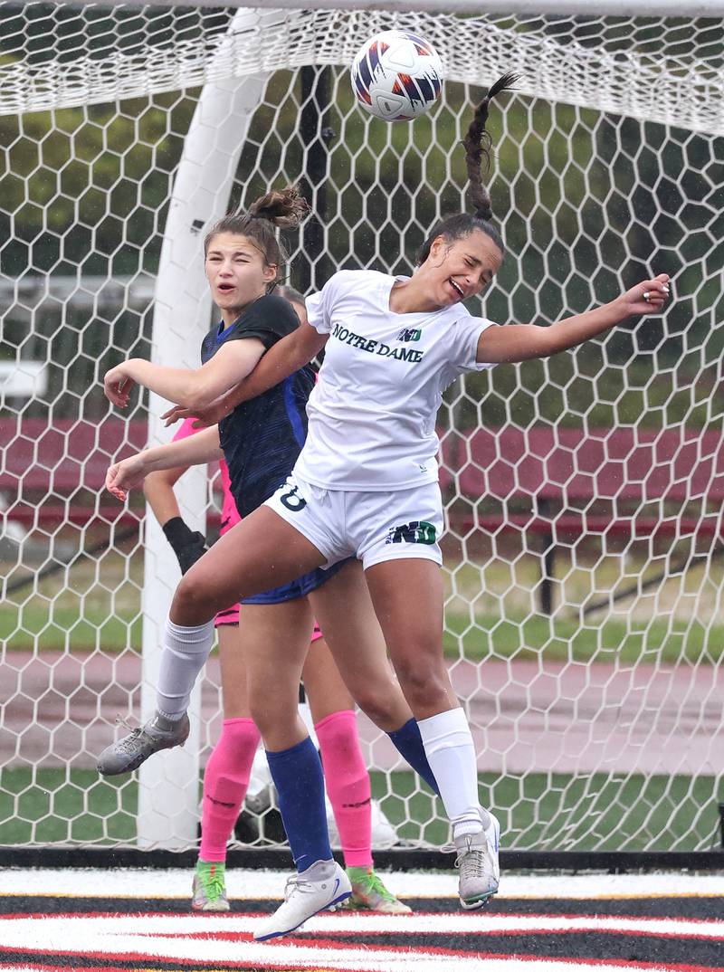 Burlington Central's Emersyn Fry (left) and Peoria Notre Dame's Ava LaFollette go up for a header during their third place game Saturday, June 1, 2024, at the IHSA Class 2A state soccer finals at North Central College in Naperville.