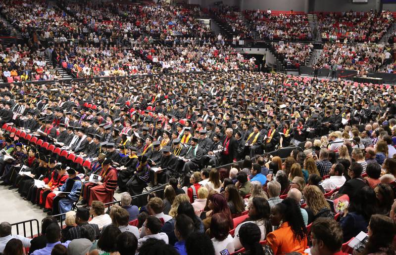 Northern Illinois University students and their families listen to speakers during the first of two undergraduate commencement ceremonies Saturday, May 11, 2024, in the Convocation Center at NIU in DeKalb.