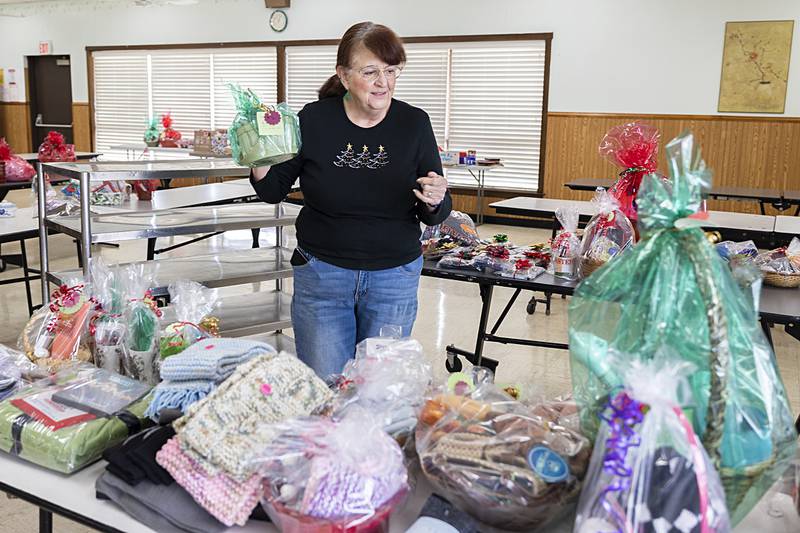 Sue Glanz of Prophetstown sets out Christmas gifts ahead of a Secret Santa Workshop for clients at Rock River Valley Self Help Enterprises in Sterling. Glanz, a board member and parent of a client, volunteered to help shop for items that clients can purchase as gifts for loved ones.