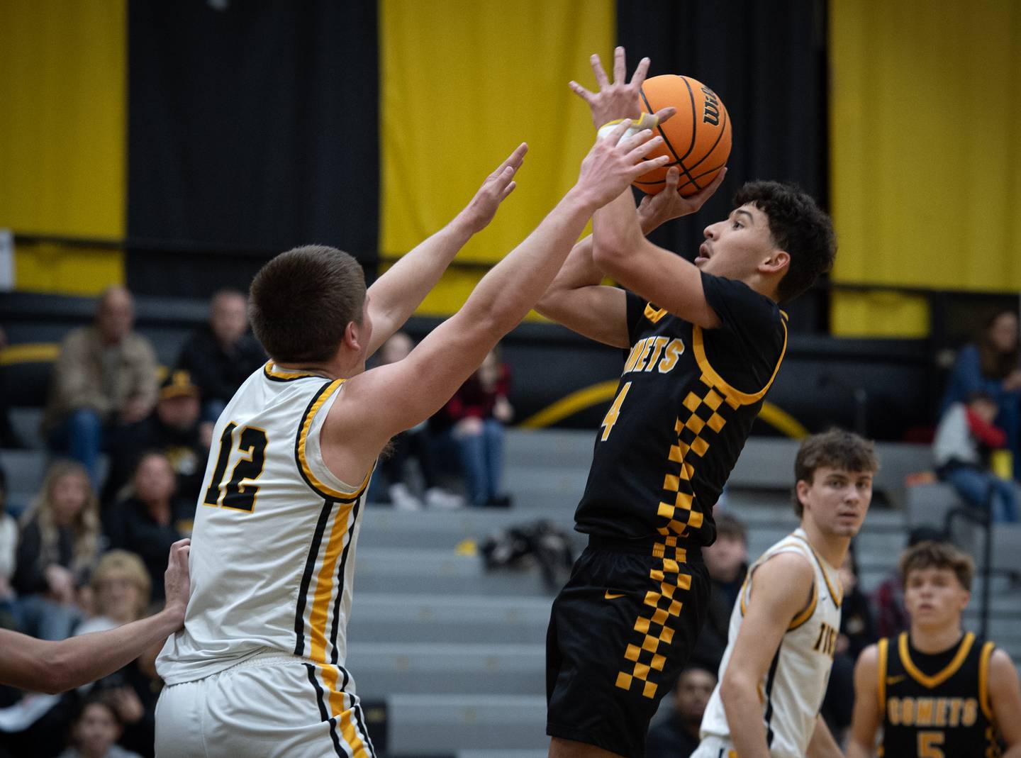 Reed-Custer's Chase Isaac, right, elevates for a shot as Herscher's Gavin Hull defends in a game on Wednesday, November 26, 2025.