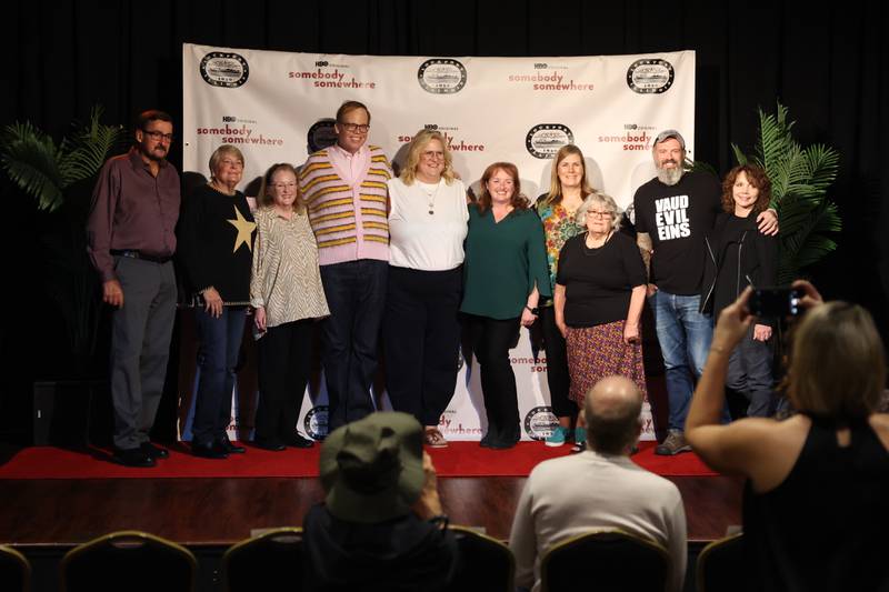 Actors Jeff Hiller and Bridget Everett, center, poses for a photo with several Lockport residents at the HBO premiere of "Somebody Somewhere" at Roxy Lockport on Wednesday, Oct. 30, 2024 in Lockport.
