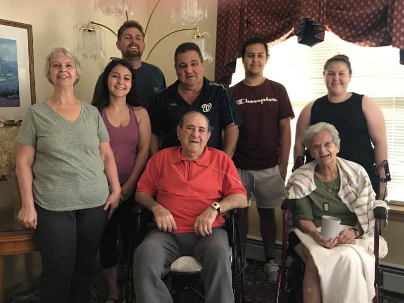 The Pastorello of Shorewood are giving away 2,000 tickets to the Joliet Slammers' Military Appreciation Night, scheduled for Saturday, Sept. 3, 2022, in honor of Joseph Pastorello (in red shirt) who died in 2019. Also pictured, from left, are Laura Pastorello, Lauren Swanson, Christian Swanson, Frank Pastorello, Charlie Pastorello, Nichole Pastorello and Anna Reisterer (seated).