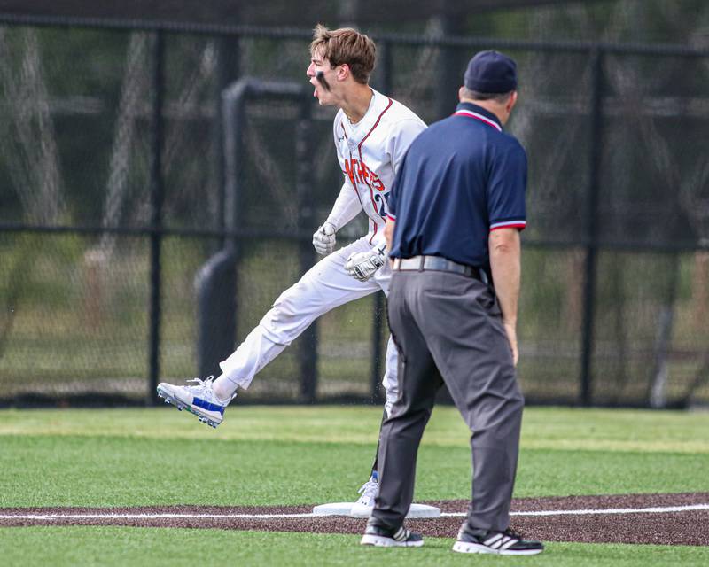 Oswego's Tyler Stack (25) yells to the dugout after sliding into third base during Class 4A Romeoville Sectional semifinal game between Plainfield North at Oswego.  June 1, 2023.