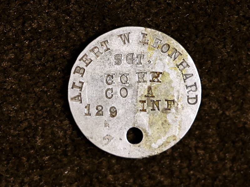 The dog tag of WWI U.S. Army soldier Albert Leonhard found inside a service record book that was purchased by DeKalb resident John Wright at a local estate sale.