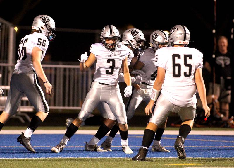 Kaneland players celebrate Sam Gagne's (3) touchdown during a game at Geneva on Friday, Sept. 3, 2021.