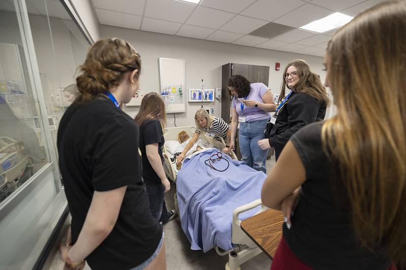 SVCC nursing instructor Meaghan Rivera uses a mannequin to show a group of aspiring health care students where to find a pulse Friday, April 17, 2026. Regional Office of Education No. 47 hosted a health care symposium at Sauk Valley Community College for high school students who have received an endorsement in health sciences. The endorsement will be part of their transcript and will benefit them for future schools and business decisions.