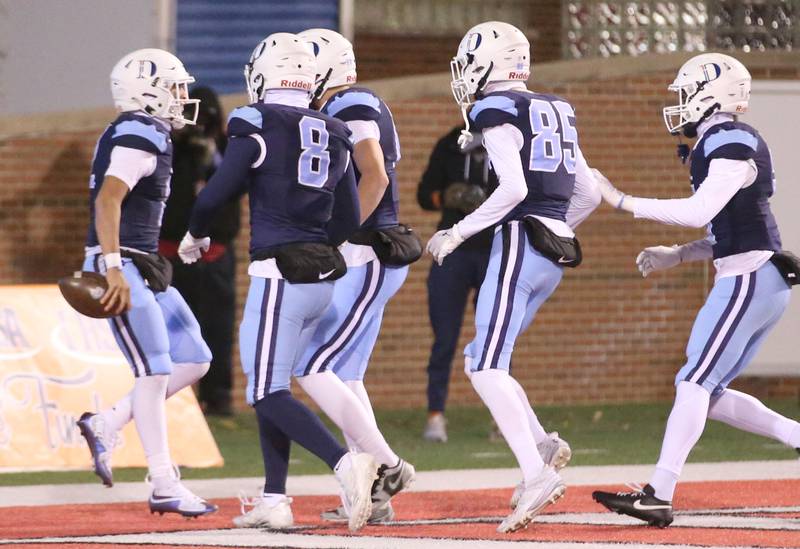 DePaul quarterback Juju Rodriguez (left) celebrates with teammates after scoring a touchdown against Mt. Zion during the Class 4A State football championship on Friday, Nov. 29, 2024 at Hancock Stadium in Normal.