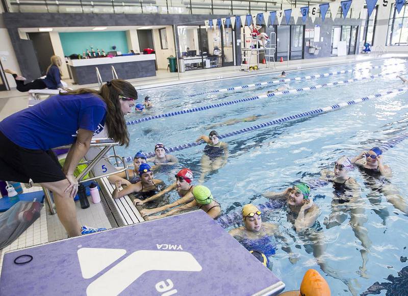 Coach Stephanie Wozny talks to the team during swim practice at Sage YMCA in Crystal Lake Wednesday, August 31, 2016.