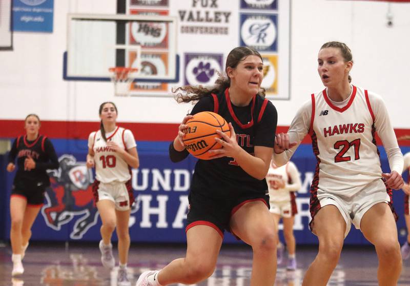 Huntley’s Paula Strzelecki, center, hustles past Maine South’s Asia Kobylarczyk, right, in Komaromy Holiday Classic varsity girls basketball championship game action on Monday, Dec. 30, 2024, at Dundee-Crown High School in Carpentersville.