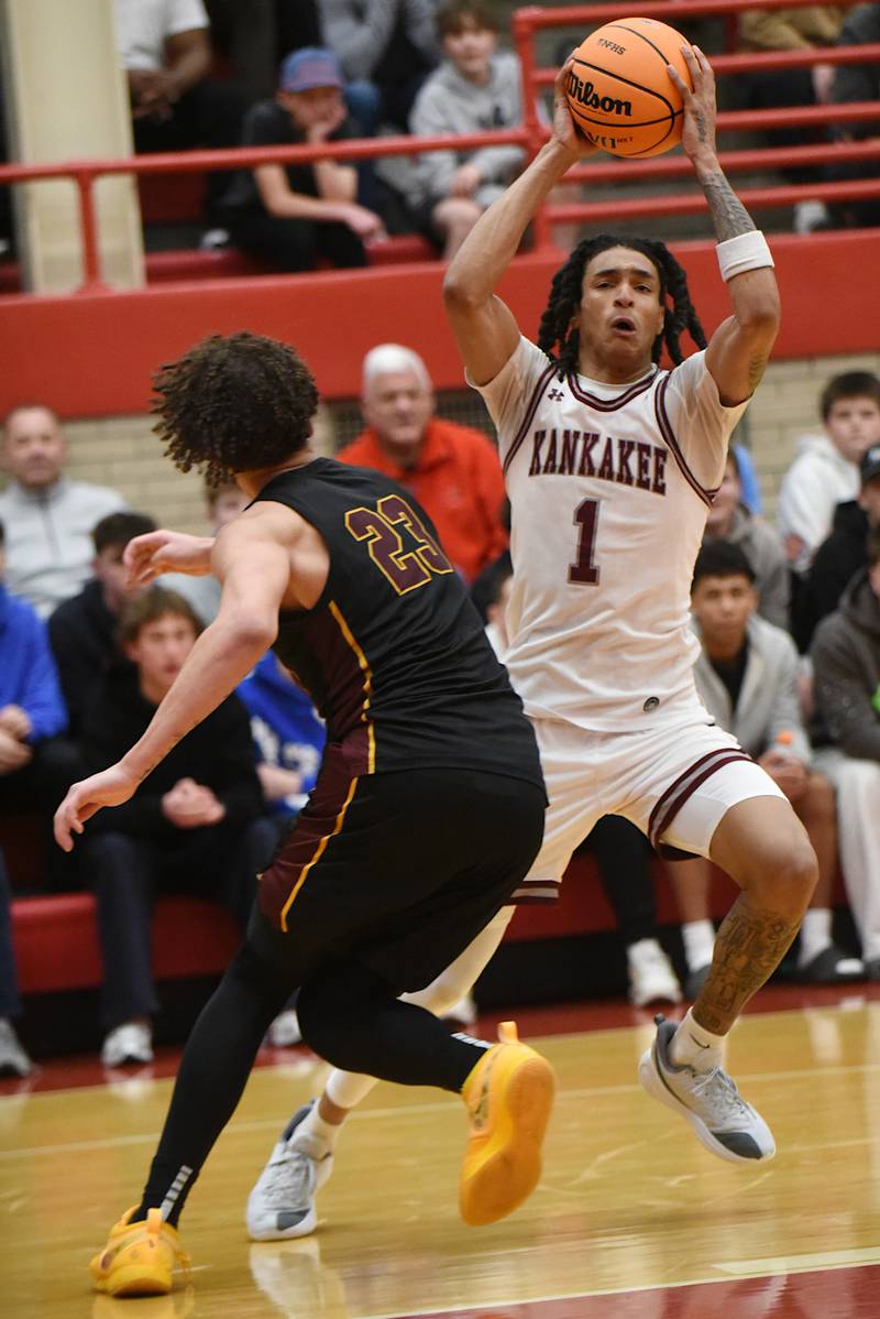 Kankakee's Lincoln Williams, right, drives past East Peoria's Quinton Kitt during the IHSA Class 3A Ottawa Sectional semifinals Wednesday, March 4, 2026.