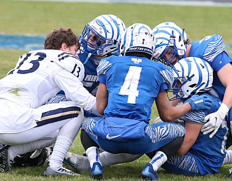 IC Catholic's JP Schmidt (13) consoles members of the Princeton football team after IC Catholic defeated Princeton in overtime in the Class 3A Quarterfinal game on Saturday, Nov. 12, 2022 in Princeton.