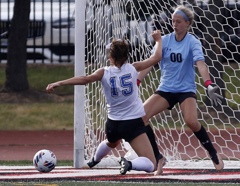 Libertyville’s Kate Hopma kicks the ball away from Lincoln-Way East's Ellie Feigl as she tries to score a goal in the IHSA Class 3A state third-place match at North Central College in Naperville on Saturday, June 3, 2023.