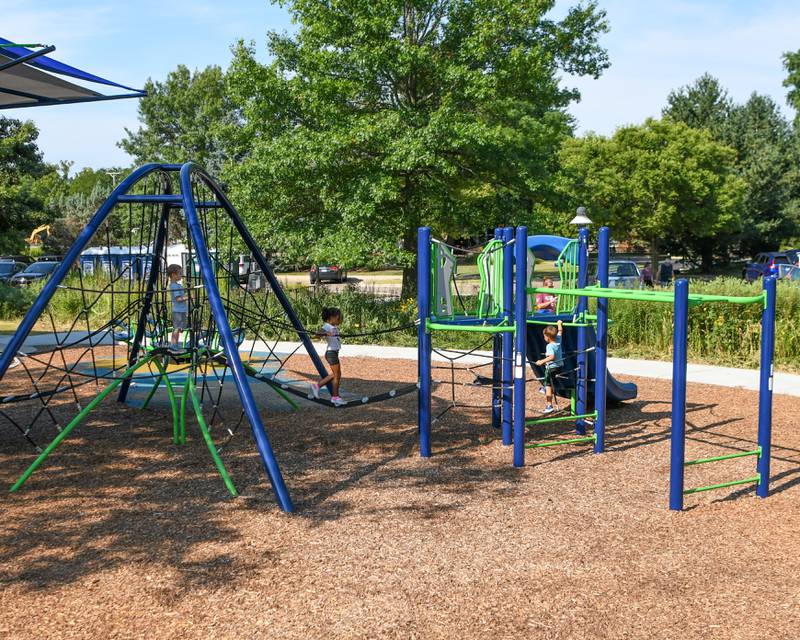 Kids enjoy using the new playground on Saturday Aug. 16, 2025, during the dedication ceremony at Prairie Park in Elburn.