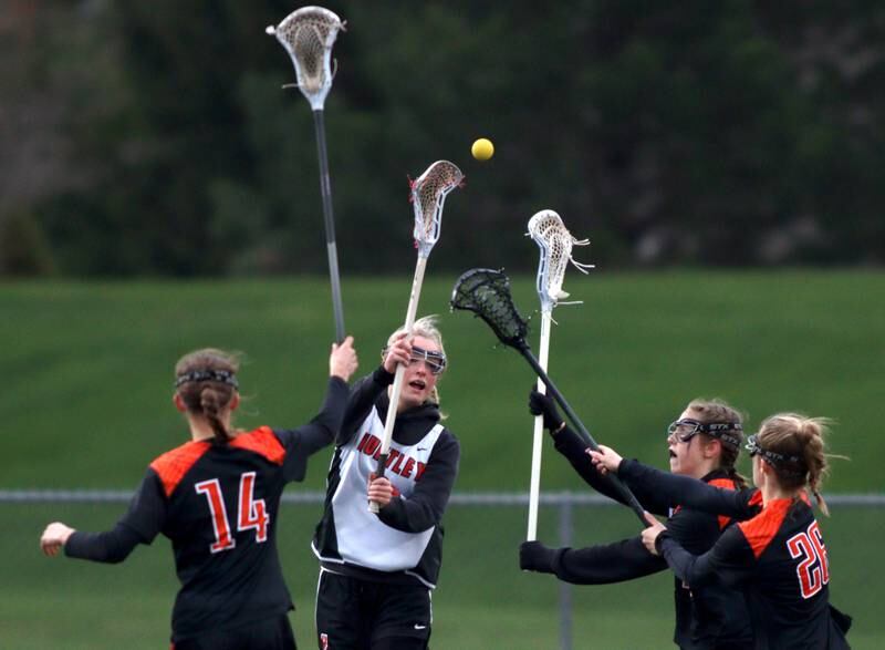 Huntley’s Lauren Cardinal passes the ball out of Crystal Lake Central’s defense in varsity lacrosse at Huntley Wednesday.