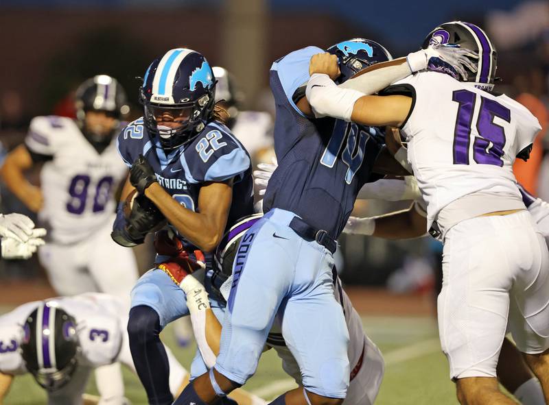 Downers Grove South Keon Maggie (22) runs the ball against Downers Grove North during the boys varsity football game on Friday, Sept. 1, 2023.