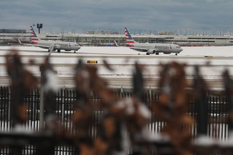American Airlines planes taxi to terminals at the O'Hare International Airport in Chicago, Sunday, Nov. 30, 2025. (AP Photo/Nam Y. Huh)