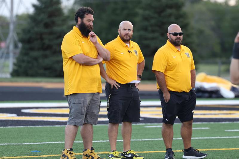 Joliet West head coach Dan Tito, center, talks with his coaches before the start of the game against Morris on Friday, Sept. 6, 2024 in Joliet.