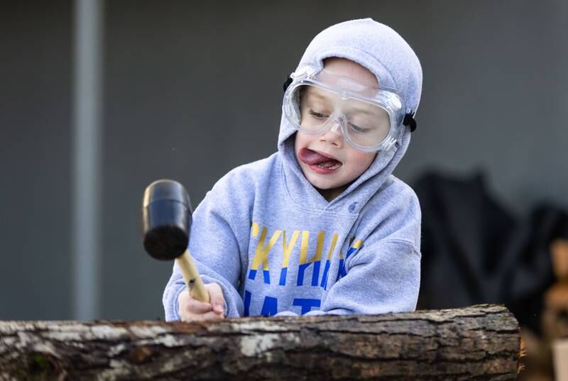 Colin Hoffmann, 5, bangs a log of wood to make cordage during the Welcome Winter Celebration at the Lost Valley Visitor Center in Ringwood on Saturday, Dec. 28, 2024. The cordage from wood was traditionally used by indigenous people for a variety of things, including clothing.