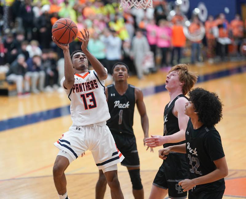 Oswego’s Bryce Woods (13) shoots the ball in the post against Oswego East during a basketball game at Oswego High School on Tuesday, Dec 12, 2023.