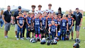 Leading by example: Oswego High School varsity football players support youth program