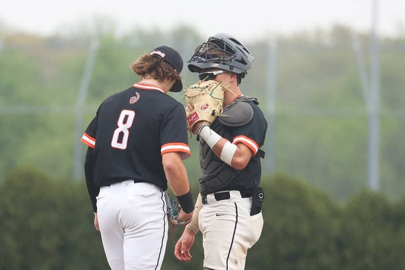 Lincoln-Way West catcher Kaleb Wilkey makes a mound visit with Conor Essenburg against Lincoln-Way Central on Monday, May 8, 2023 in New Lenox.