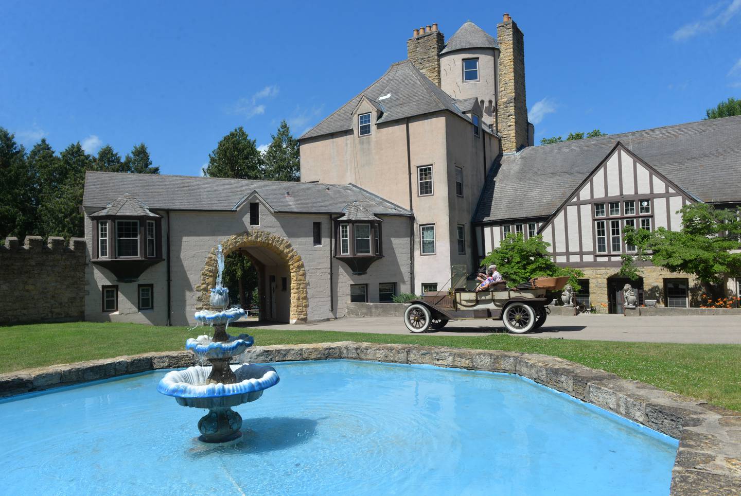 Joe and Dawn Somers, of Lindenwood, drive their 1911 Austin touring car past the Stronghold Castle while taking part in the Nashional Car Show at the Stronghold Camp & Retreat Center north of Oregon on Saturday, June 29, 2024.