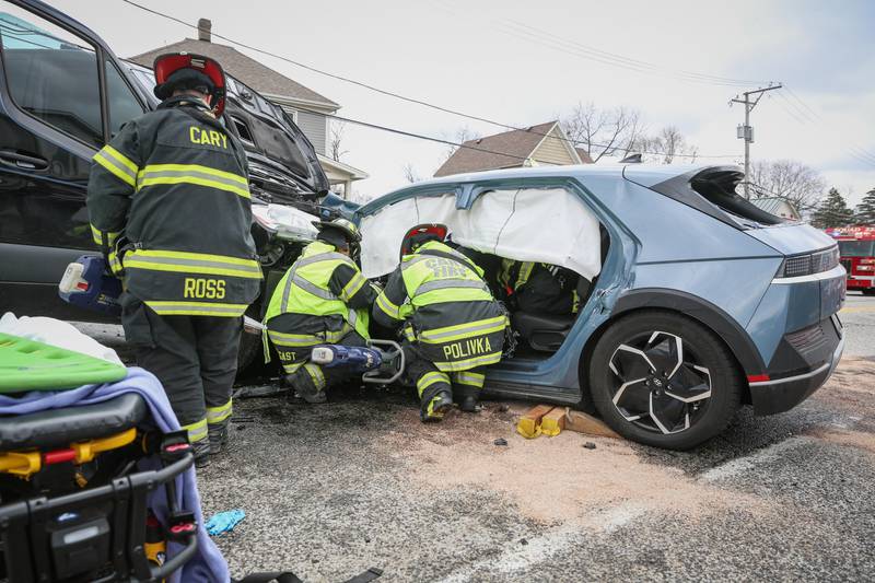 Firefighters rush to the scene of a two-vehicle crash with a driver who was entrapped in their vehicle for almost 40 minutes in Cary on Tuesday, April 19, 2022.