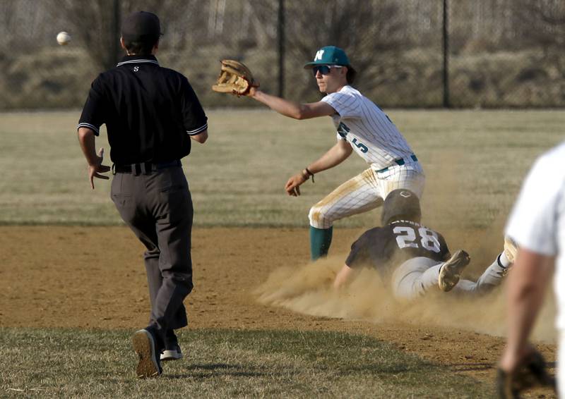 Woodstock North's Tristan Schaffter waits for the throw as Cary-Grove's Brock Iverson slides into second base during a nonconference baseball game on Monday, March 30, 2026, at Woodstock North High School.
