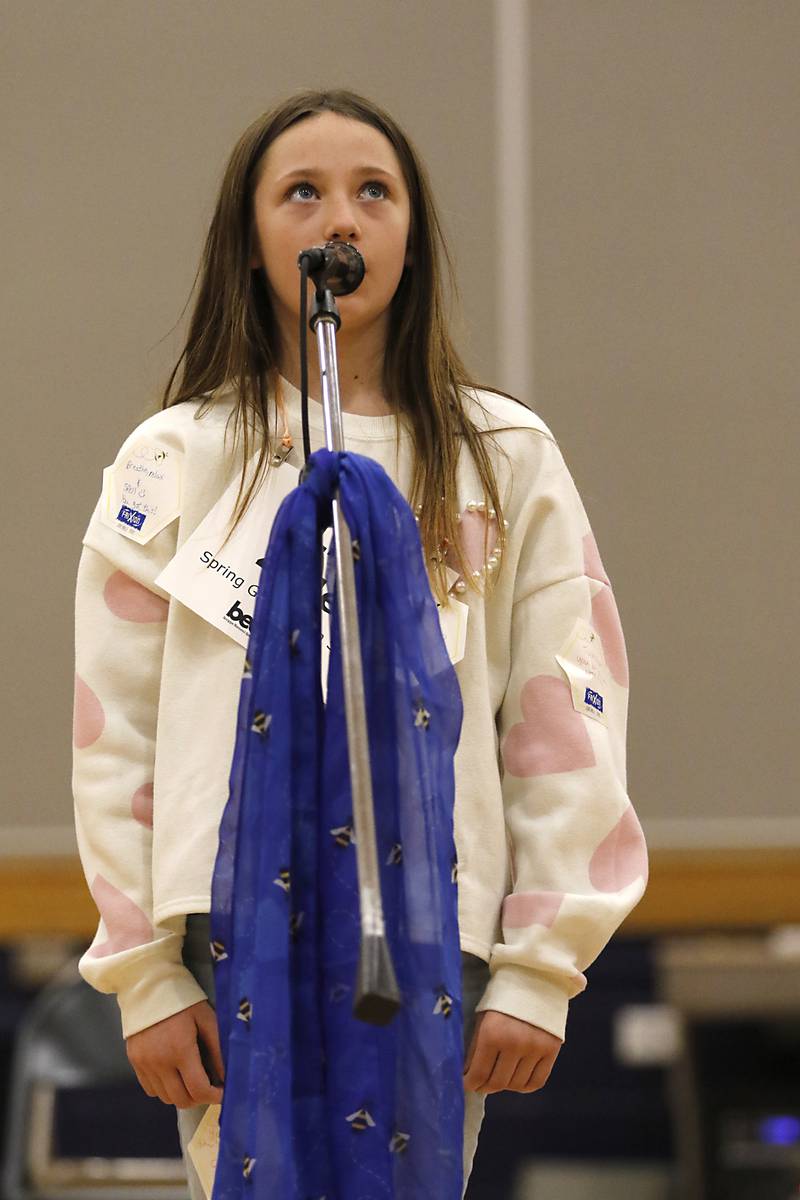 Lia Zollor, a student at Spring Grove Elementary School, looks up as she spells a word during the McHenry County Regional Office of Education’s 2025 Spelling Bee on Wednesday, March 19, 2025, at Bernotas Middle School in Crystal Lake.