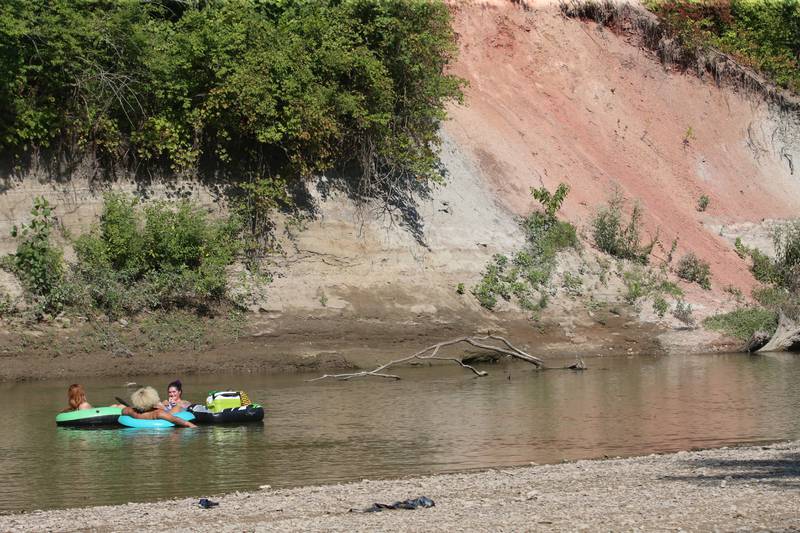 Brea Faux of Peru, Kerri Herman of Spring Valley and Lana Ramsey of Spring Valley cool off on inner tubes on Wednesday, Aug. 23, 2023 in Oglesby.