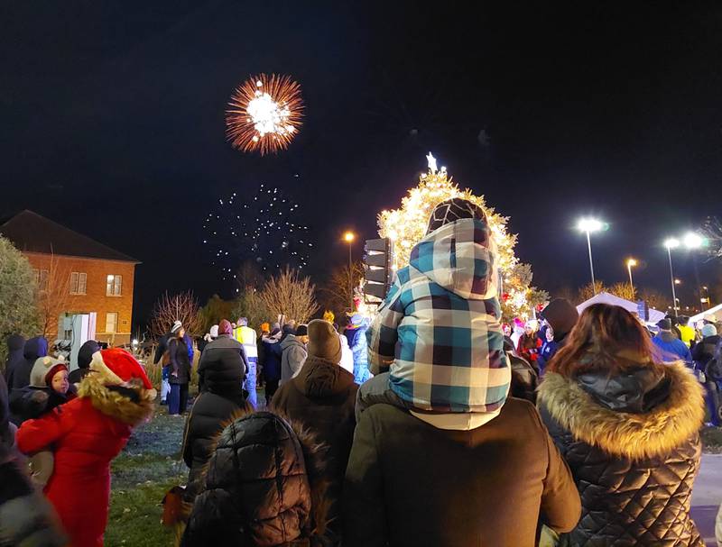 Families gathered around the Christmas tree in the Jordan block to watch a fireworks show Friday, Nov. 24, 2023, during the Festival of Lights in Ottawa.