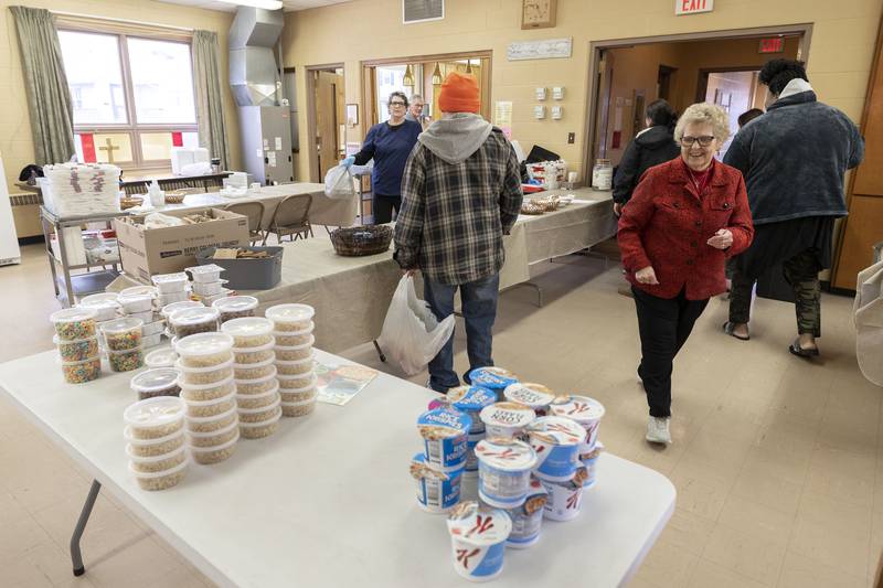 Director Lois Heerdt (right) interacts with regular clients who come through the door Wednesday, March 29, 2023. With just a few days left in March, Loaves and Fishes has given out over 1850 breakfasts this month.