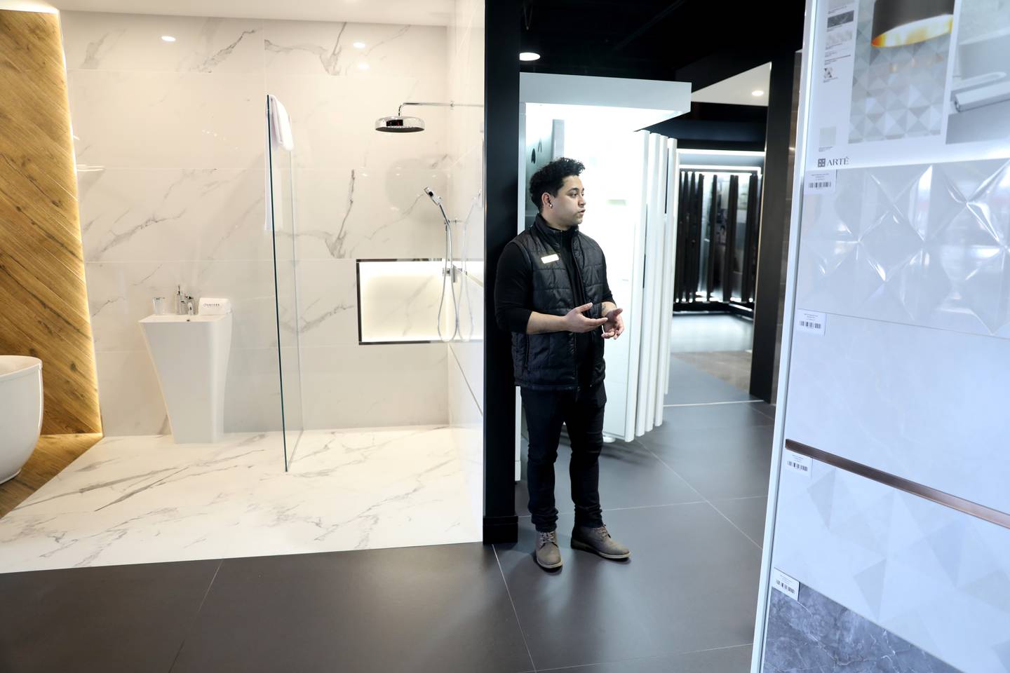 Sales representaive Justin Ortiz gives a tour of the new Encore Gallery, which recently opened a 20,000-square-foot showroom in the former Binnys location in St. Charles. Encore Gallery is an importer, distributor and supplier of porcelain and ceramic tiles, preserved moss and other home design products from Europe.