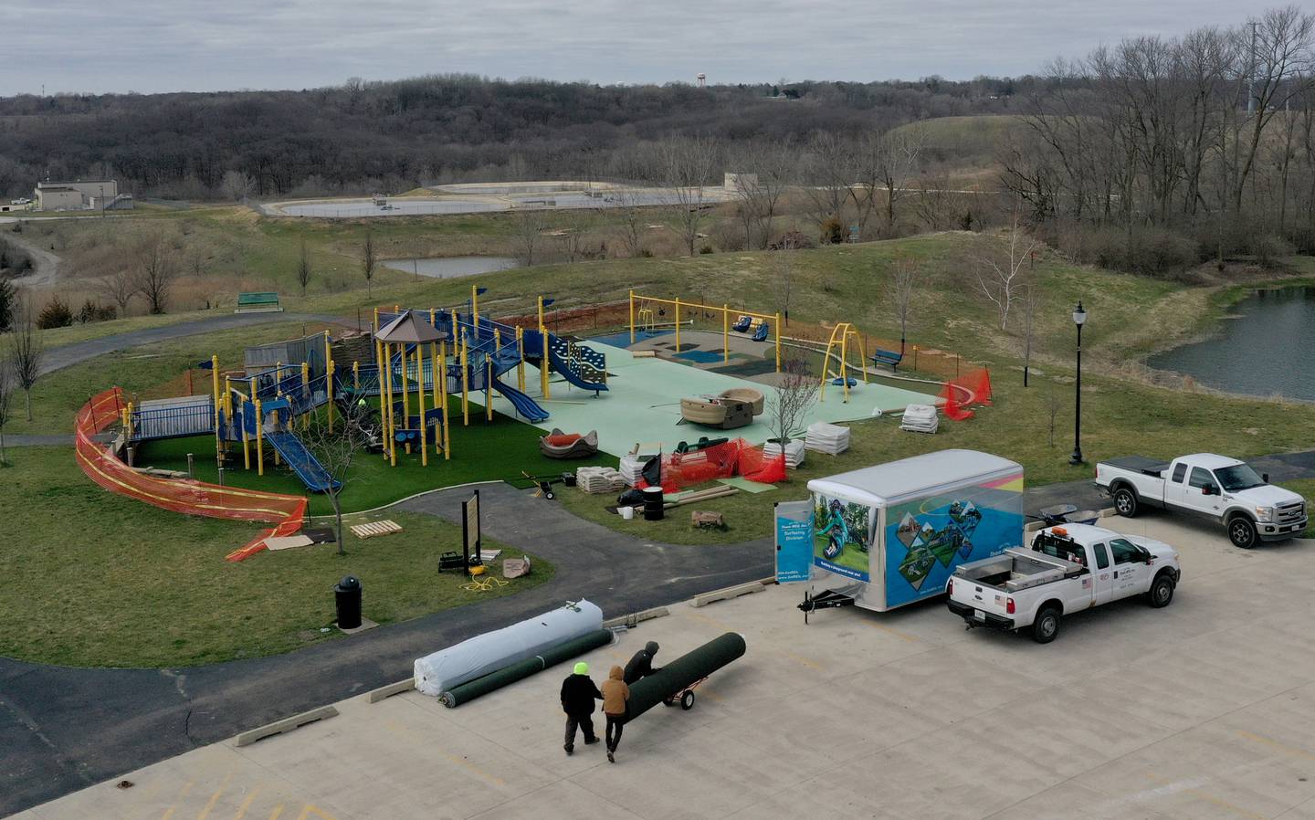 A crew from Teim Reil Inc. install new artificial turf at the playground at Rotary Park on Monday, March 18, 2024 in La Salle. The playground will be re-surfaced and completed on March 25. The playground will be closed until work is finished.