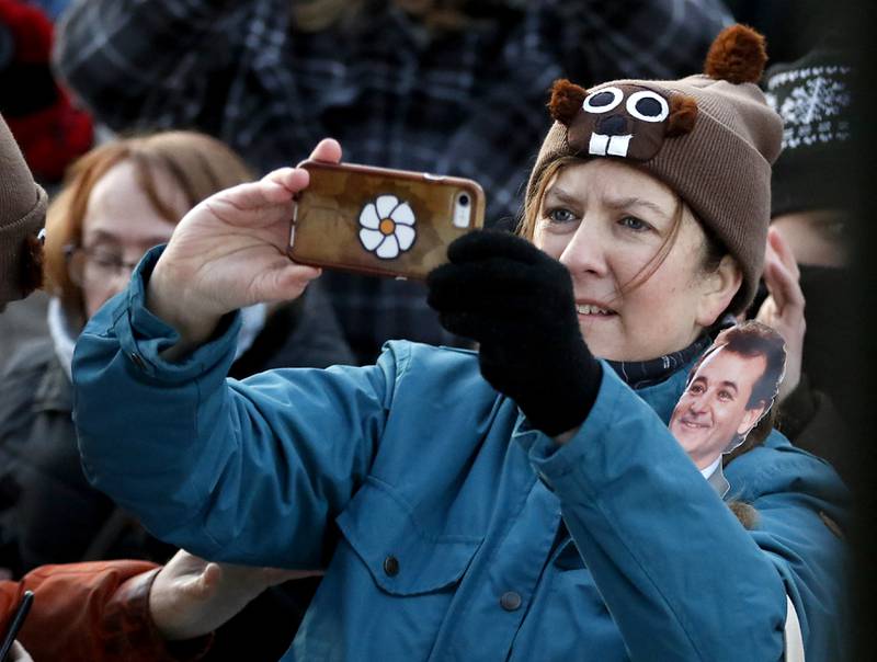 A woman photographs Woodstock Willie as he makes his prognostication of six more weeks of winter Thursday, Feb, 2, 2023, during the annual Groundhog Day Prognostication on the Woodstock Square.