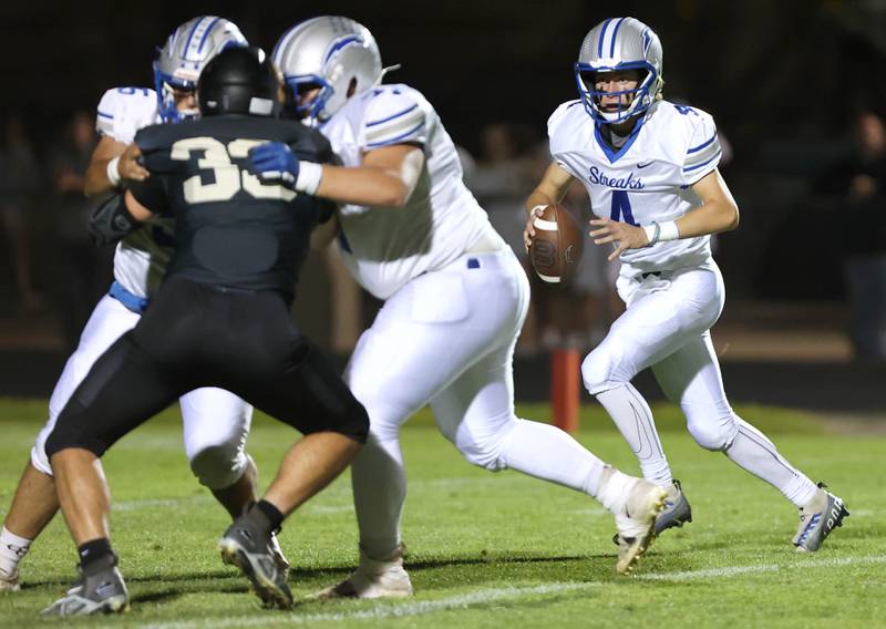 Woodstock's Caden Thompson drops back to pass during their game Friday, Sept. 8, 2023, at Sycamore High School.