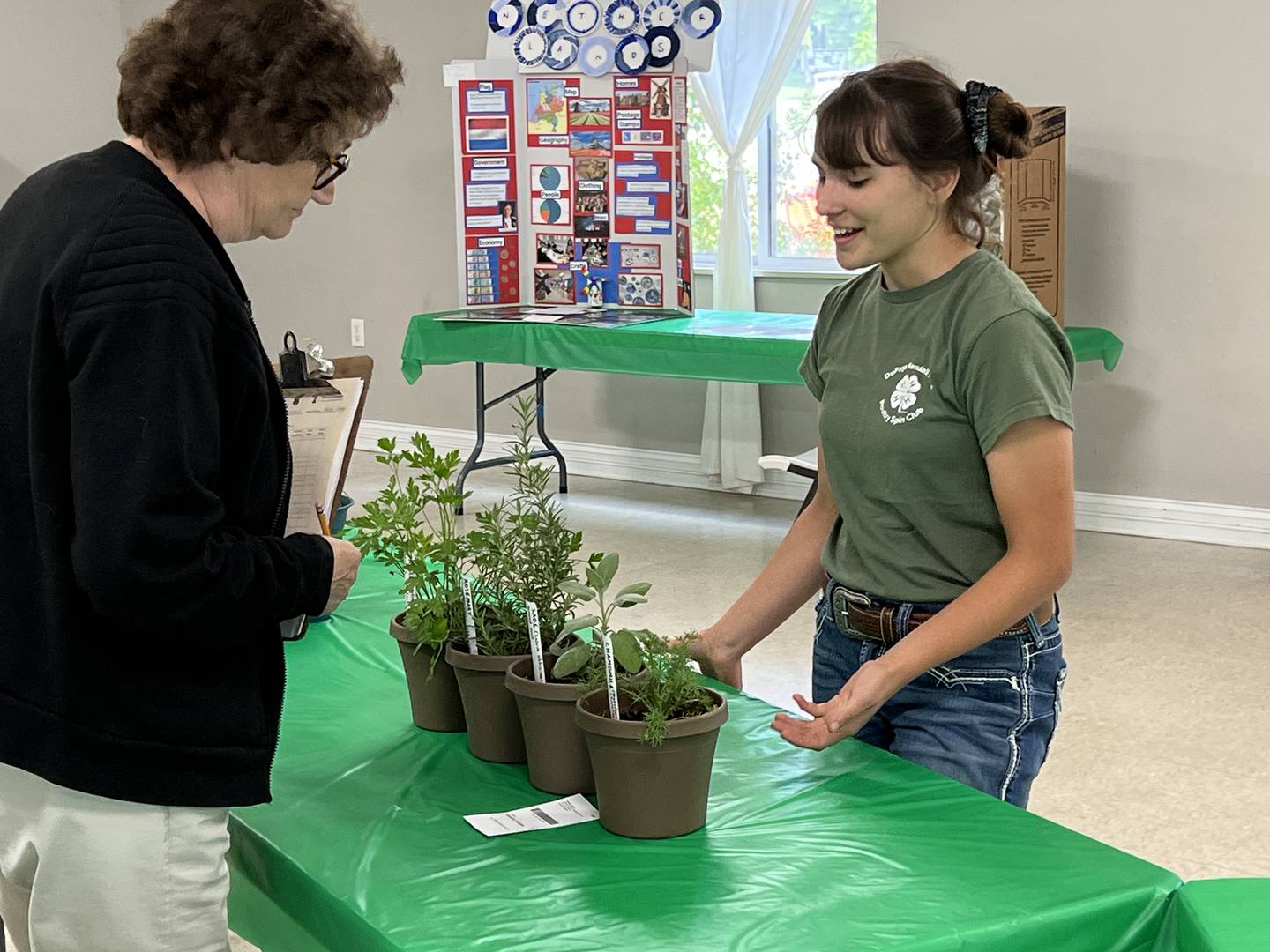 Faustina Krysciak of Yorkville discusses her herbs project with a Master Gardener.