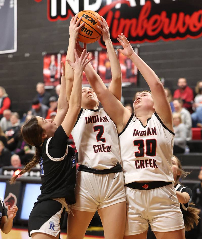 Indian Creek's Gretta Oziah middle and Indian Creek's Madison Boehne go after a rebound against Rosary Tuesday, Feb. 10, 2026, during their game at Indian Creek High School in Shabbona.