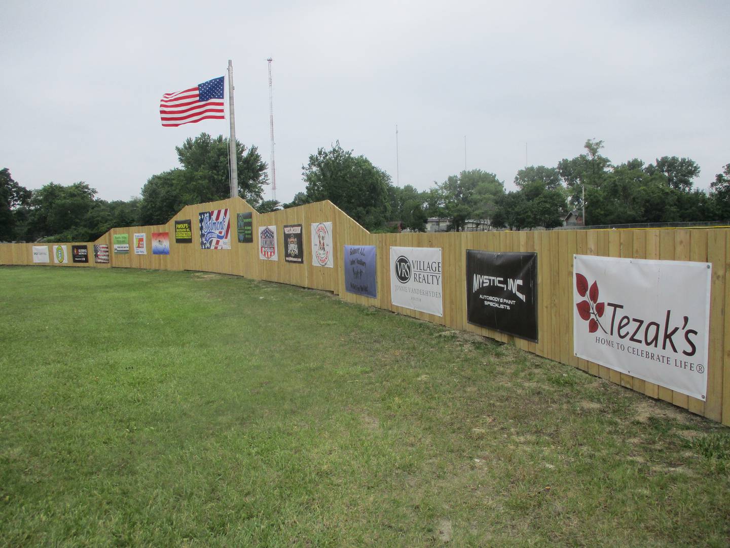 A new outfield fence, funded with a $28,000 contribution from the Joliet Rotary Club, carries banners of the many businesses and organizations that support the Belmont Little League in Joliet. June 14, 2025