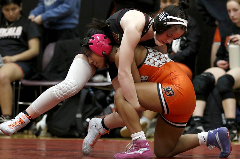 Morris’ Maggie Gordon tries to get out of the grasp of DeKalb’s Alex Gregorio-Perez in the 110-pound match of a nononference wrestling meet on Wednesday, Jan. 22, 2025, at Huntley High School.