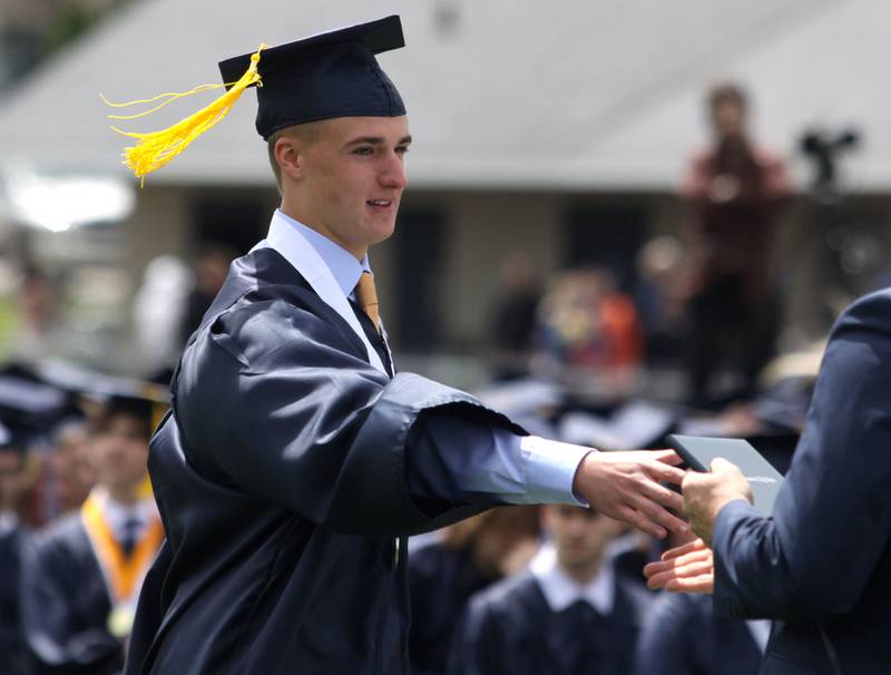 Brayden Tamason receives his diploma during graduation at Cary-Grove High School in Cary on Saturday, May 17, 2025.