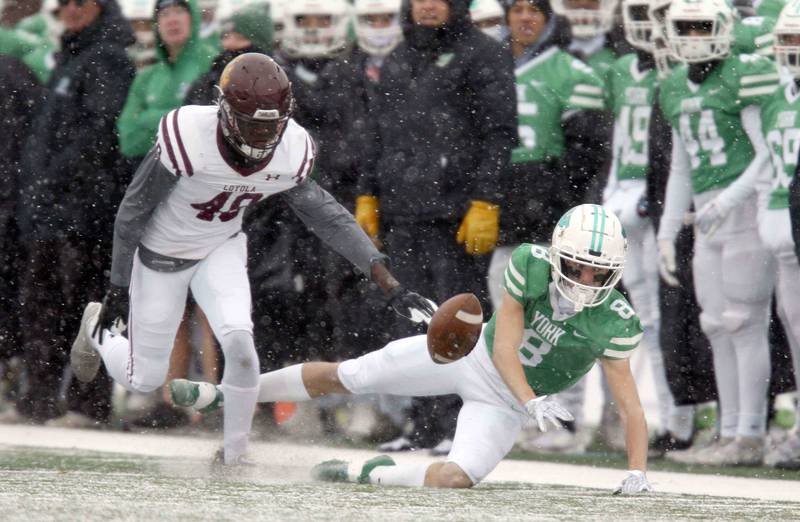Loyola's Emmanuel Ofosu (49) and York’s Charlie Specht (8) nearly collide while diving for an errant pass during the IHSA Class 8A semifinal football game Saturday November 19, 2022 in Elmhurst.