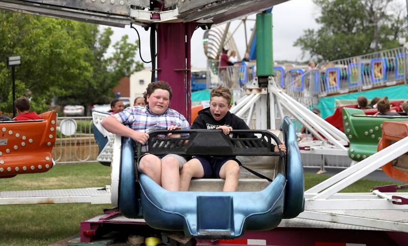 Duke Johnson, 12, of Sycamore (left) and Ryan Lind, 12, of Maple Park ride The Scrambler during the 156th Annual Kane County Fair on Thursday, July 17, 2025 in St. Charles. The fair runs through Sunday, July 20, 2025.