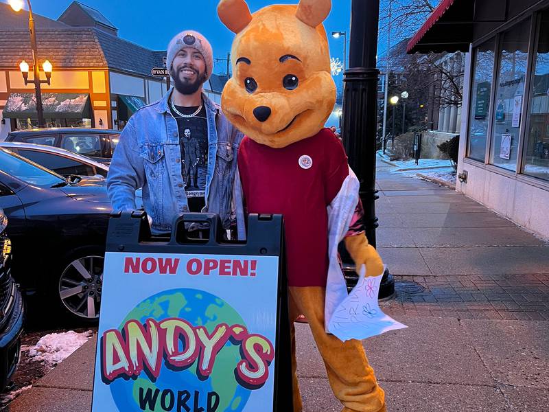 Andrew Rios of Andy's World takes a photo with Winnie the Pooh during Groundhog festivities in Woodstock.
