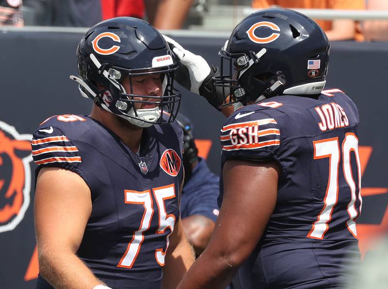 Chicago Bears offensive tackle Ozzy Trapilo (left) and offensive tackle Braxton Jones get together during warmups Sunday, Aug. 10, 2025, before their preseason game against the Miami Dolphins at Soldier Field in Chicago.