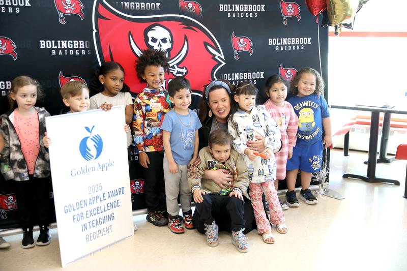 Bolingbrook High School teacher Erin Clifford poses with some of her Little Raiders Preschool students after it was announced she had won a Golden Apple Award for Excellence in Teaching.