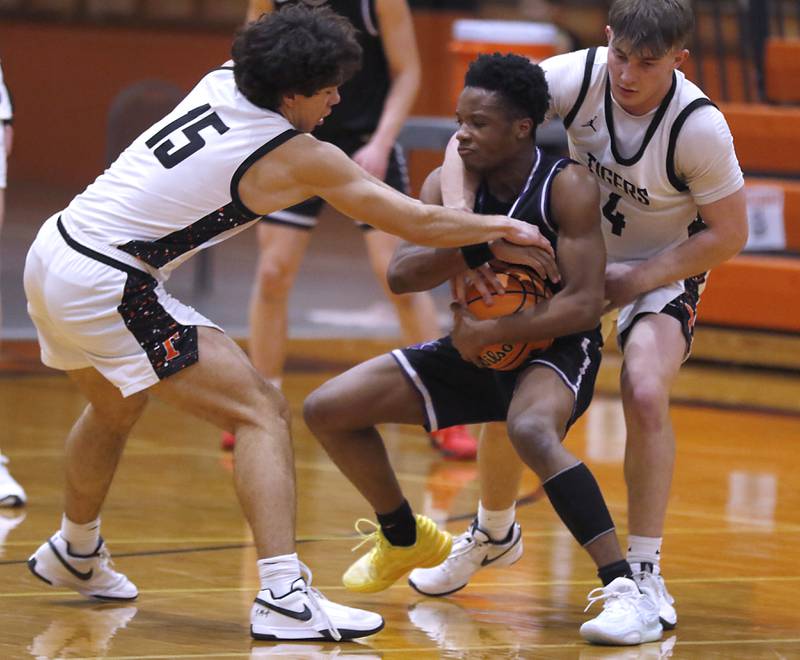 Crystal Lake Central's Mason Alvarez (left) and Crystal Lake Central's Carter Kelley, (right) trie to steal the ball from Hampshire's Chayse Gray during a a Fox Valley Conference basketball game on Friday, Feb. 7, 2025, at Crystal Lake Central High School.